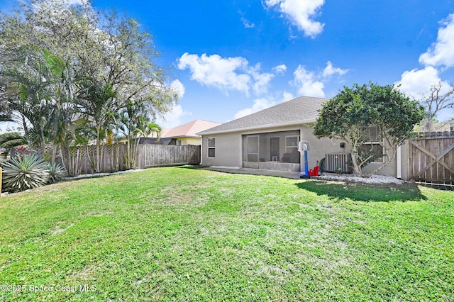 view of yard featuring a fenced backyard, a sunroom, and cooling unit