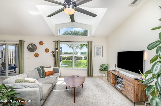 2464 Bayhill Dr, Melbourne, FL 32940 - living area with vaulted ceiling, ceiling fan, light tile patterned floors, and baseboards