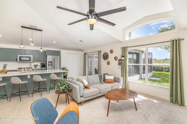 2464 Bayhill Dr, Melbourne, FL 32940 - living room with high vaulted ceiling, light tile patterned floors, ceiling fan, and recessed lighting