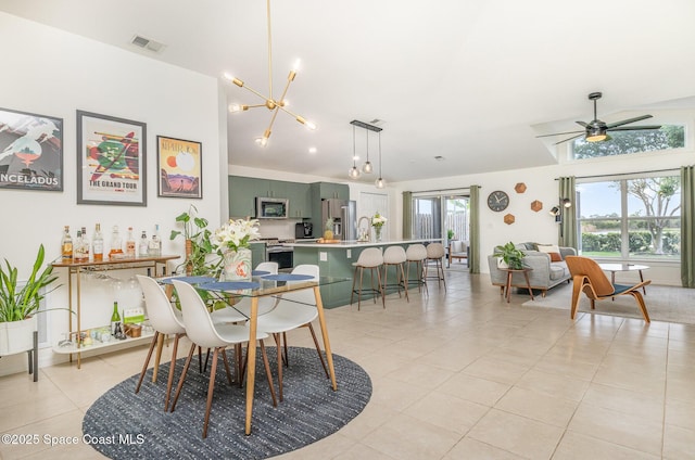 2464 Bayhill Dr, Melbourne, FL 32940 - dining area featuring light tile patterned floors, a chandelier, and a ceiling fan