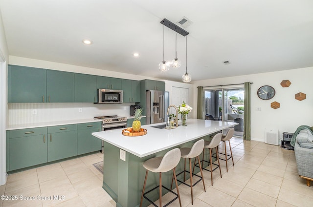 2464 Bayhill Dr, Melbourne, FL 32940 - kitchen with appliances with stainless steel finishes, light tile patterned floors, a sink, light countertops, and a breakfast bar area