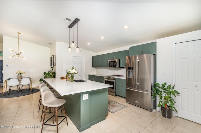 2464 Bayhill Dr, Melbourne, FL 32940 - kitchen featuring appliances with stainless steel finishes, green cabinets, vaulted ceiling, a chandelier, and light tile patterned flooring