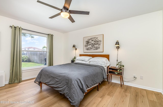 2464 Bayhill Dr, Melbourne, FL 32940 - bedroom featuring light wood finished floors, baseboards, and ceiling fan