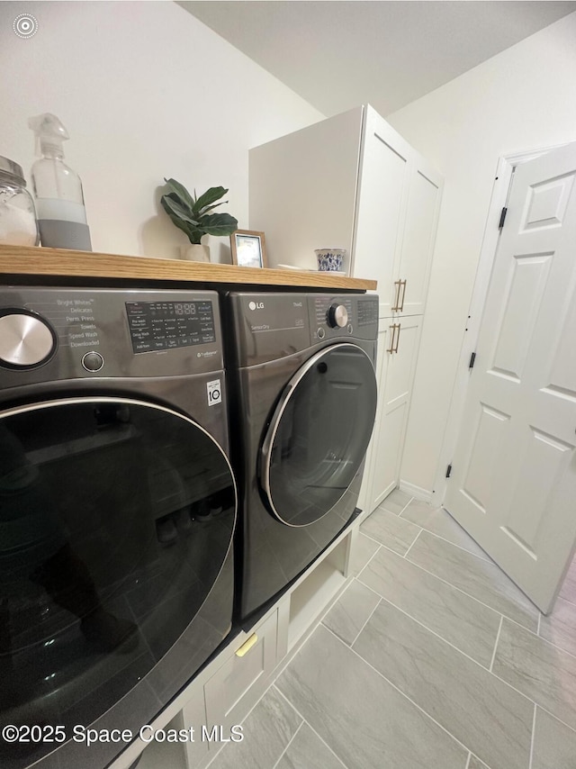 2464 Bayhill Dr, Melbourne, FL 32940 - laundry room featuring washer and clothes dryer and light marble finish flooring