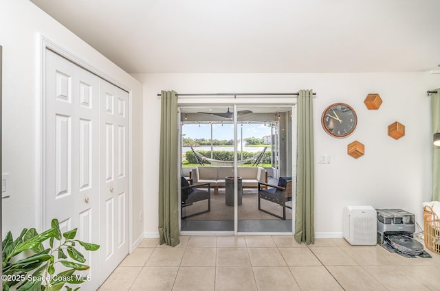2464 Bayhill Dr, Melbourne, FL 32940 - doorway to outside with light tile patterned floors, baseboards, and a water view