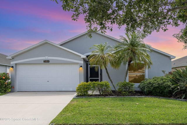 2464 Bayhill Dr, Melbourne, FL 32940 - single story home featuring an attached garage, concrete driveway, a lawn, and stucco siding