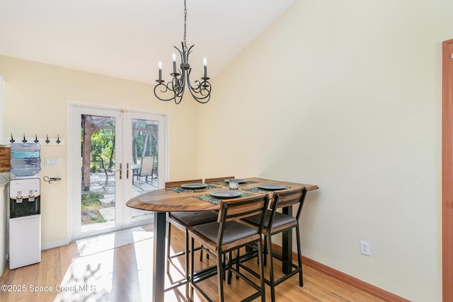 1435 Xavier Ave SE, Palm Bay, FL 32909 - dining room with an inviting chandelier, light wood-style floors, french doors, baseboards, and vaulted ceiling