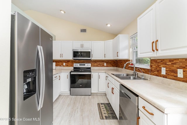 1435 Xavier Ave SE, Palm Bay, FL 32909 - kitchen with white cabinetry, appliances with stainless steel finishes, a sink, and visible vents