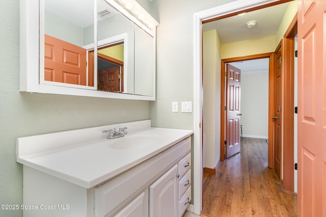 1435 Xavier Ave SE, Palm Bay, FL 32909 - bathroom featuring visible vents, wood finished floors, and vanity