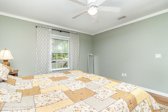 1435 Xavier Ave SE, Palm Bay, FL 32909 - bedroom with a ceiling fan, baseboards, wood finished floors, visible vents, and ornamental molding