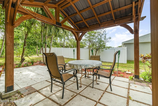 1435 Xavier Ave SE, Palm Bay, FL 32909 - view of patio / terrace with fence, outdoor dining area, and a gazebo