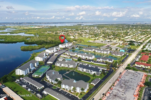 aerial view of property and surrounding area with a large body of water