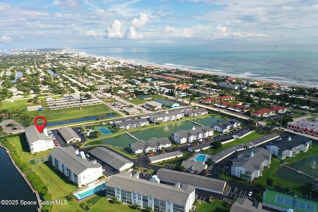 aerial view of property and surrounding area featuring a nearby body of water
