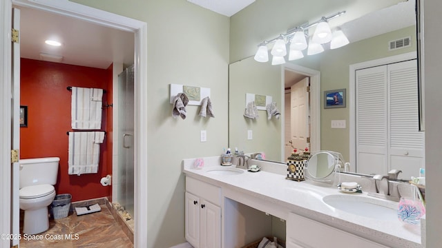 full bathroom with toilet, a closet, double vanity, marble finish floors, and a shower stall