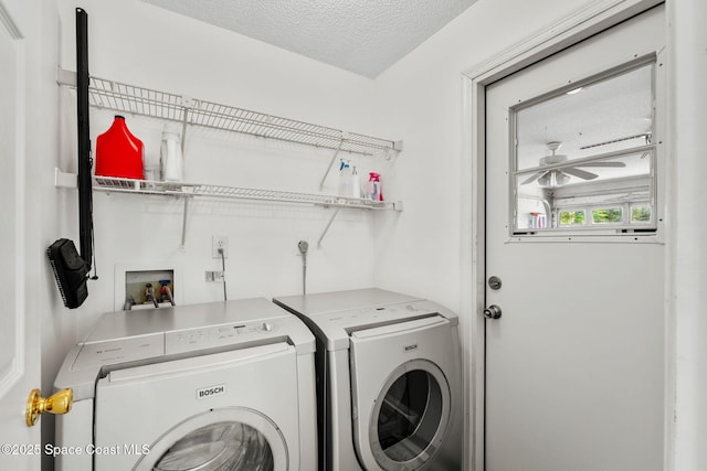 clothes washing area featuring washer and clothes dryer, laundry area, a textured ceiling, and ceiling fan