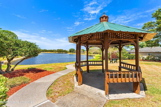 view of community with a yard, a gazebo, and a water view