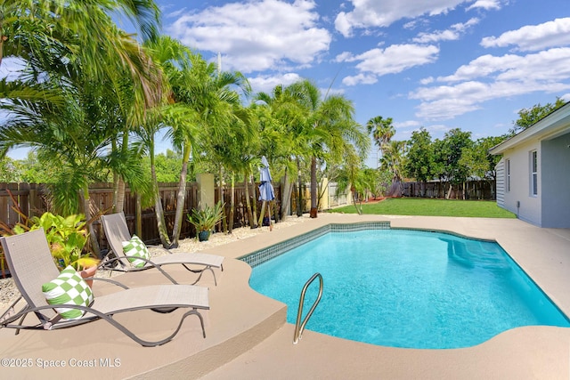 view of swimming pool featuring a lawn, a patio area, a fenced in pool, and a fenced backyard