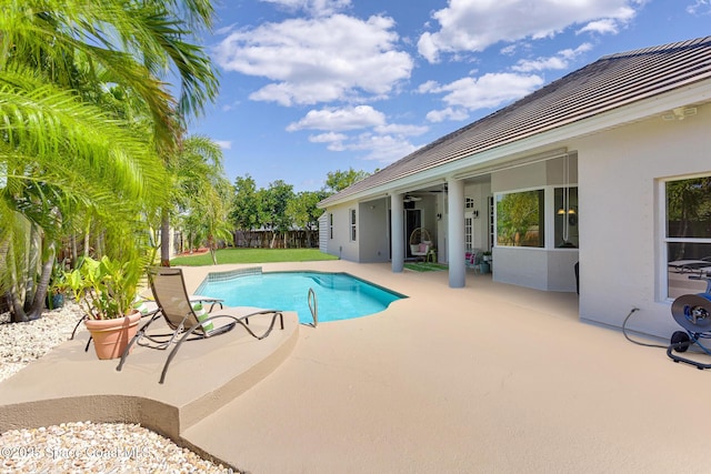 view of swimming pool with a patio area, a fenced in pool, and fence