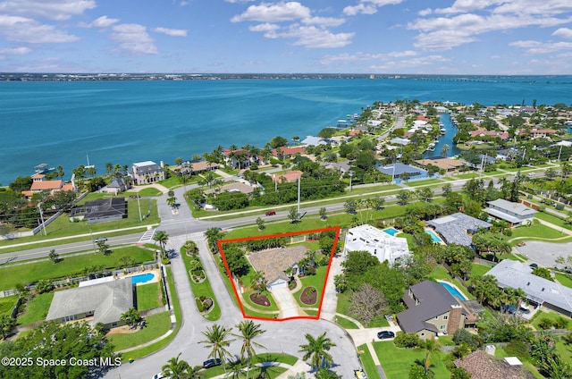 birds eye view of property with a water view and a residential view