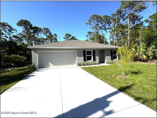 single story home with stucco siding, an attached garage, driveway, and a front lawn
