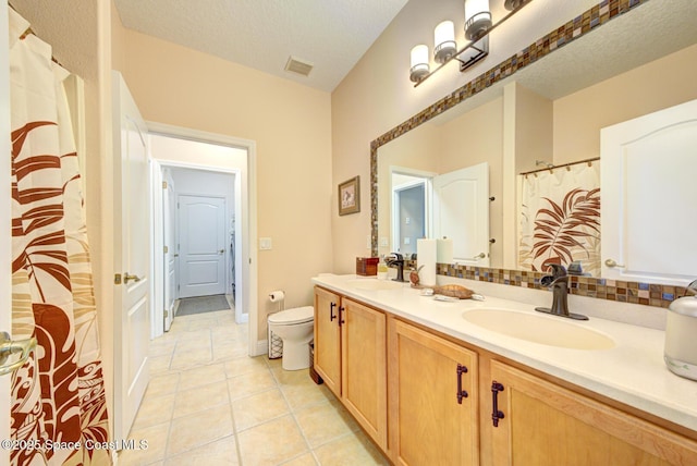 full bathroom featuring a sink, tile patterned floors, toilet, and visible vents
