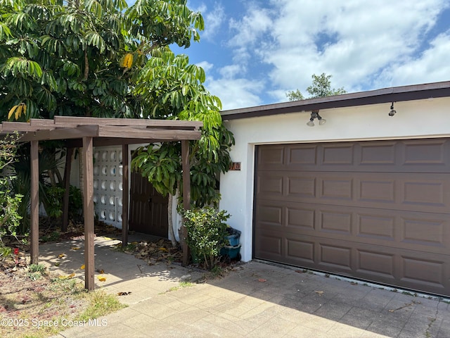 garage with concrete driveway