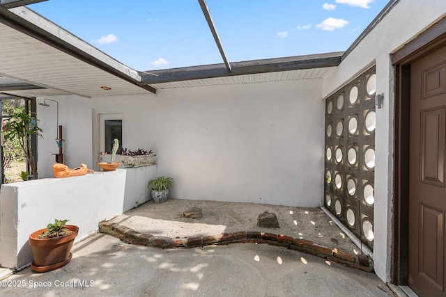 107 Algonquin Ter, Indian Harbour Beach, FL 32937 - property entrance with stucco siding and a patio