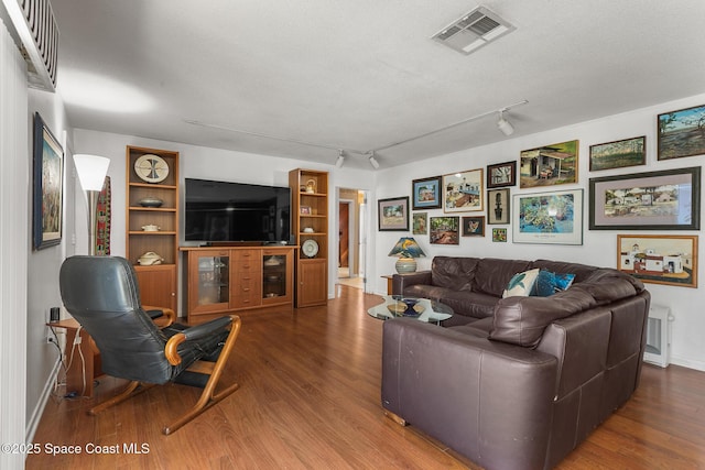 107 Algonquin Ter, Indian Harbour Beach, FL 32937 - living room featuring wood finished floors, baseboards, and rail lighting