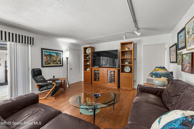 107 Algonquin Ter, Indian Harbour Beach, FL 32937 - living room featuring a textured ceiling and wood finished floors