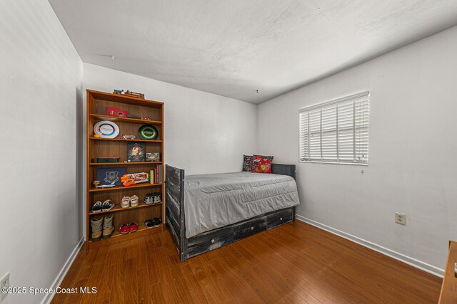 107 Algonquin Ter, Indian Harbour Beach, FL 32937 - bedroom with wood finished floors and baseboards