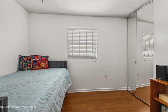 107 Algonquin Ter, Indian Harbour Beach, FL 32937 - bedroom featuring wood finished floors, multiple windows, and baseboards