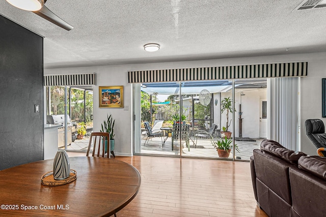 107 Algonquin Ter, Indian Harbour Beach, FL 32937 - dining area featuring a textured ceiling and wood-type flooring