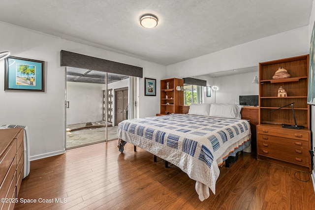 107 Algonquin Ter, Indian Harbour Beach, FL 32937 - bedroom featuring access to outside, dark wood-style floors, and baseboards