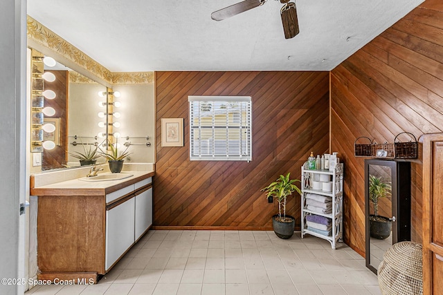 107 Algonquin Ter, Indian Harbour Beach, FL 32937 - bathroom with wood walls, a ceiling fan, vanity, and baseboards