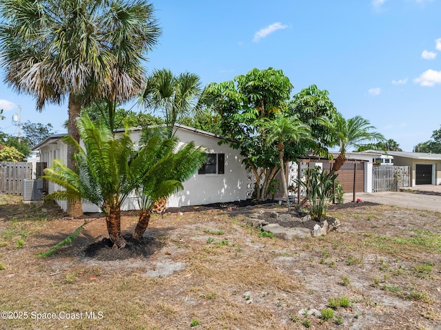 107 Algonquin Ter, Indian Harbour Beach, FL 32937 - view of front of home featuring fence, cooling unit, driveway, and an attached garage