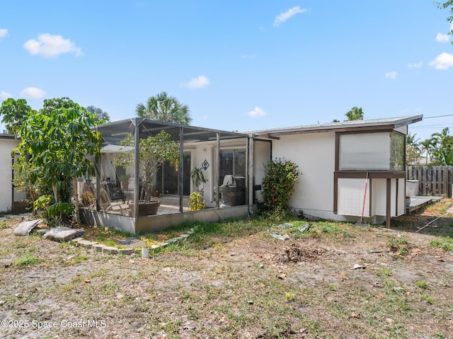 107 Algonquin Ter, Indian Harbour Beach, FL 32937 - rear view of house with glass enclosure, a patio, and fence
