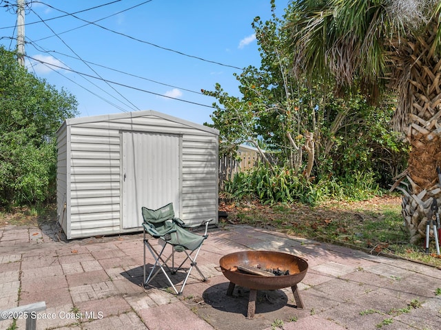 107 Algonquin Ter, Indian Harbour Beach, FL 32937 - view of patio featuring a storage shed, an outdoor structure, and fence