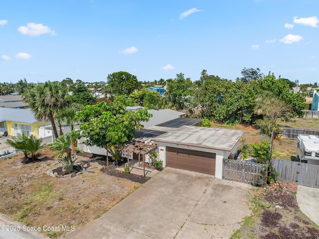 107 Algonquin Ter, Indian Harbour Beach, FL 32937 - view of front of house featuring an attached garage, fence, driveway, solar panels, and a gate