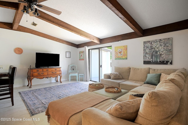 living room featuring ceiling fan, light tile patterned floors, and baseboards