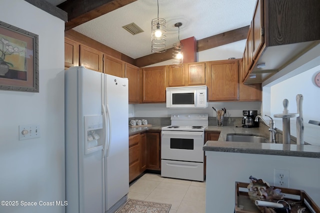 kitchen featuring white appliances, a sink, light tile patterned flooring, brown cabinetry, and a textured ceiling