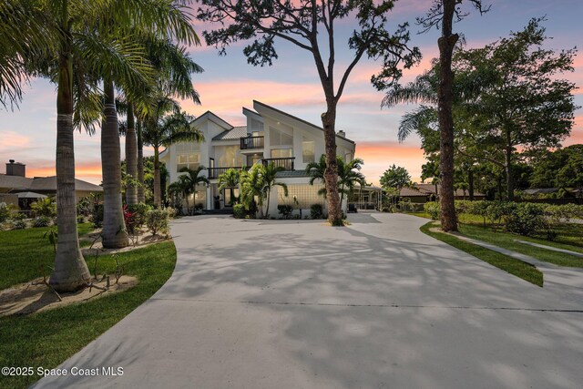 1495 Newfound Harbor Dr, Merritt Island, FL 32952 - view of front of house with curved driveway and a balcony