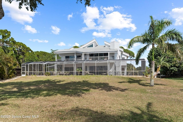 1495 Newfound Harbor Dr, Merritt Island, FL 32952 - back of house featuring a lawn, a tile roof, a lanai, and a balcony