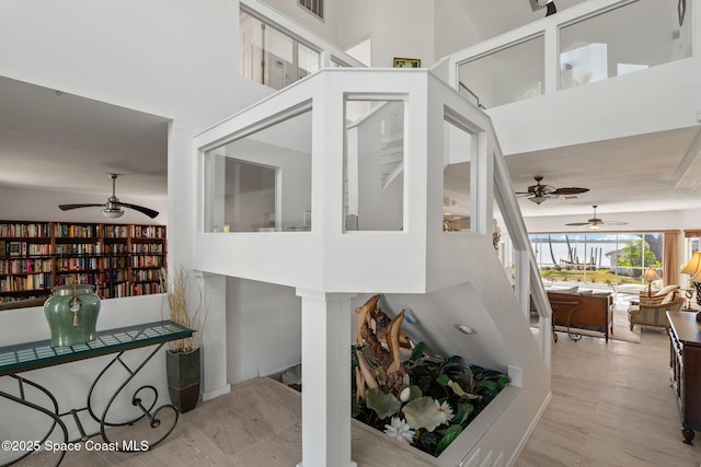 1495 Newfound Harbor Dr, Merritt Island, FL 32952 - staircase with visible vents, a ceiling fan, and a towering ceiling