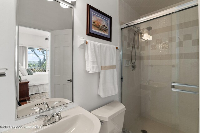 1495 Newfound Harbor Dr, Merritt Island, FL 32952 - ensuite bathroom featuring a stall shower, a sink, ensuite bath, and toilet