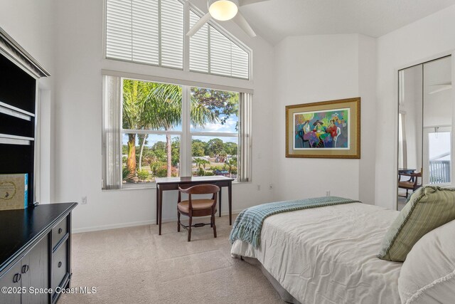 1495 Newfound Harbor Dr, Merritt Island, FL 32952 - bedroom with baseboards, light colored carpet, multiple windows, and a high ceiling