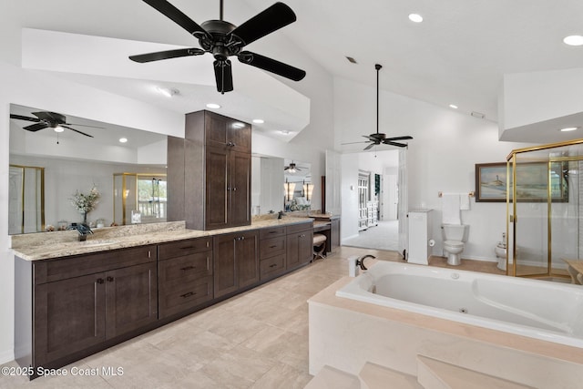 1495 Newfound Harbor Dr, Merritt Island, FL 32952 - bathroom with ceiling fan, vanity, toilet, a jetted tub, and a stall shower