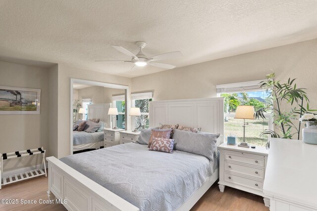 1495 Newfound Harbor Dr, Merritt Island, FL 32952 - bedroom with a textured ceiling, ceiling fan, and wood finished floors