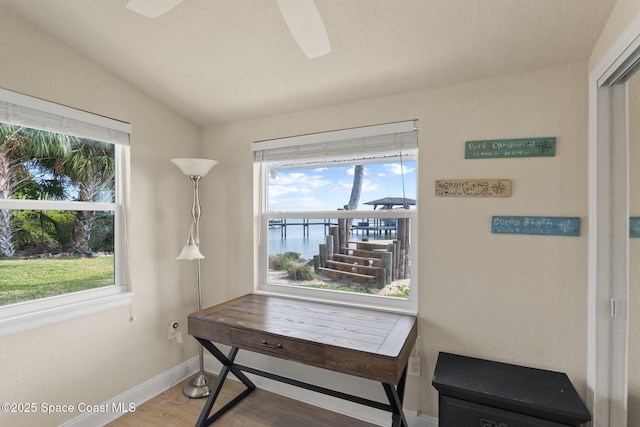 1495 Newfound Harbor Dr, Merritt Island, FL 32952 - home office with baseboards, ceiling fan, a healthy amount of sunlight, and wood finished floors