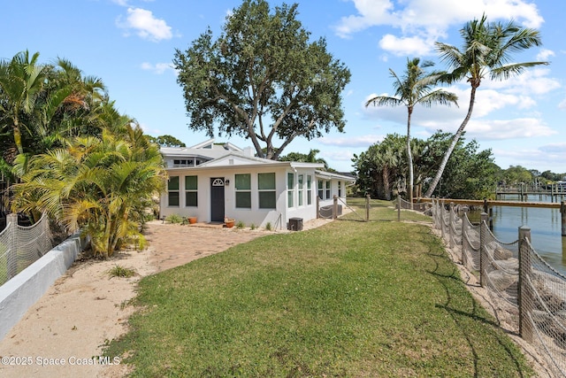 1495 Newfound Harbor Dr, Merritt Island, FL 32952 - exterior space featuring a yard, fence, and stucco siding