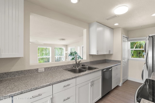 1495 Newfound Harbor Dr, Merritt Island, FL 32952 - kitchen with visible vents, a sink, appliances with stainless steel finishes, and white cabinets